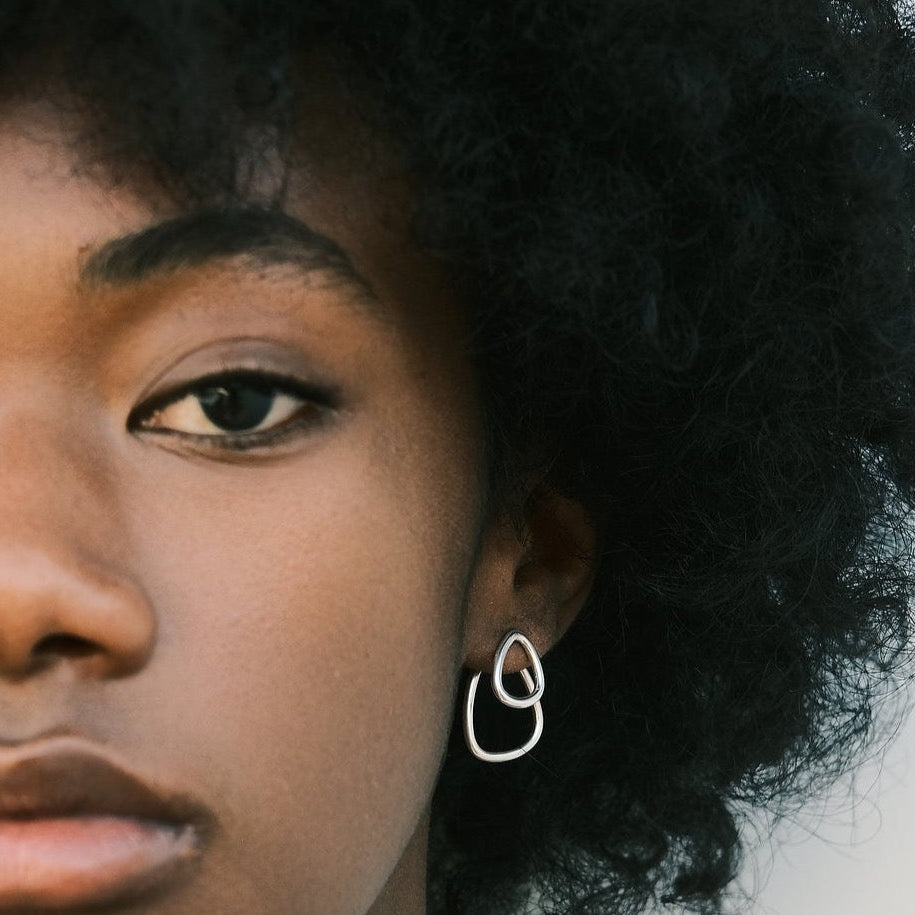 Evidence Stone is wearing the Silver Héméra Ombrée Earrings by Aurore Havenne